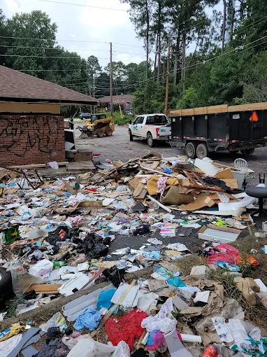 GoGo Junk Removal Truck and Trailer r backed up and ready to collect debris from lot dumping. Professional Lot Cleanup to to meet city ordinance and regulations and preventing fines. Lot Clean up, Same Day booking in Decatur, Ga.