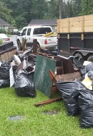 GoGo Junk Removal truck parked curbside for a large bulk move-out and trash-out cleanup.